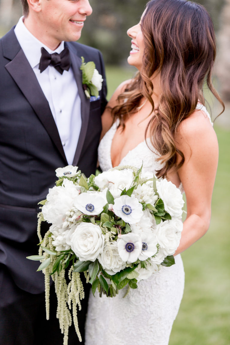couple smiling with bouquet