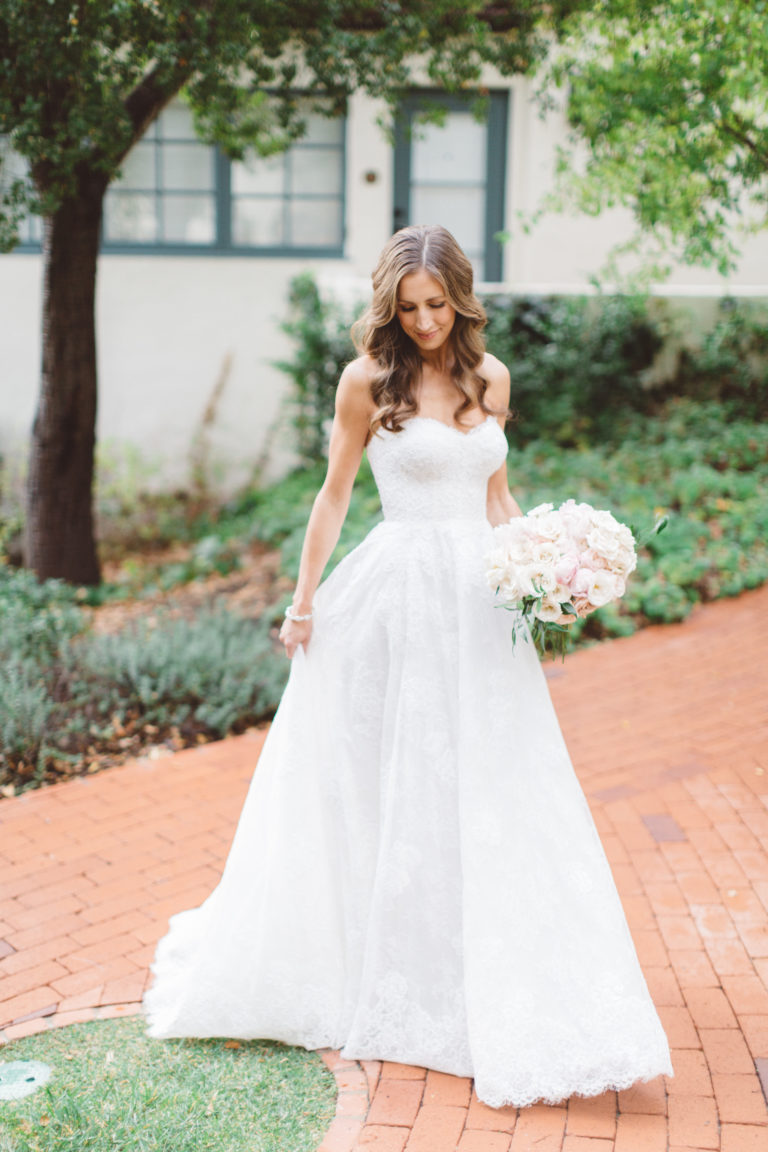 bride with romantic gown and pink bouquet
