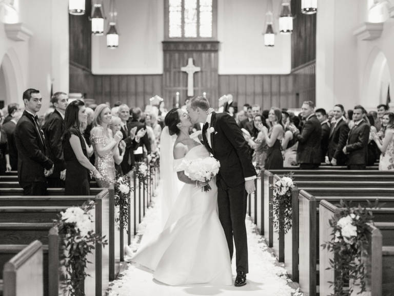 bride and groom kiss in church