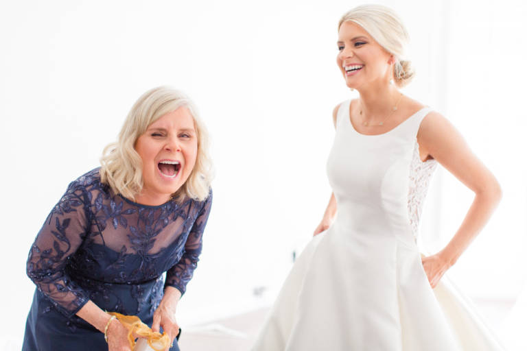 bride and mother laughing