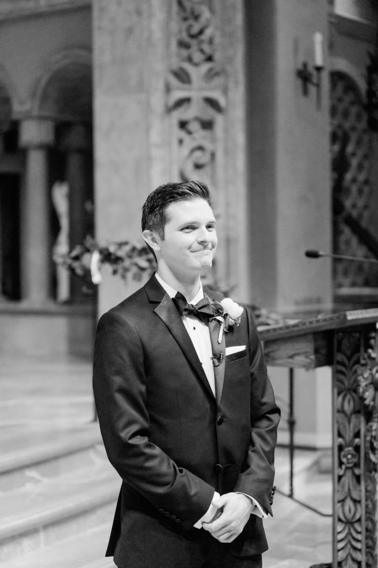 groom waits for bride at altar