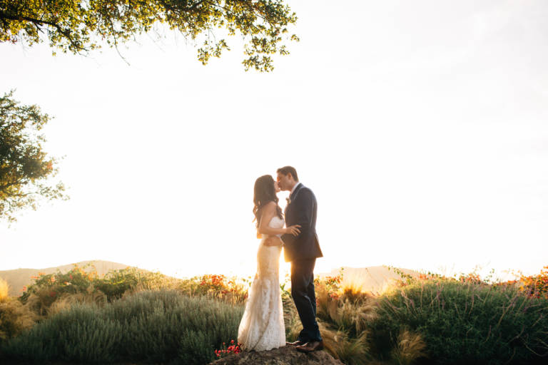 bride and groom sunset kiss